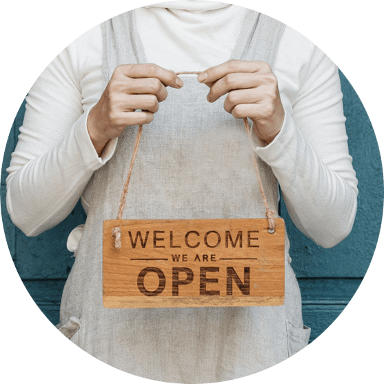 woman holding open sign